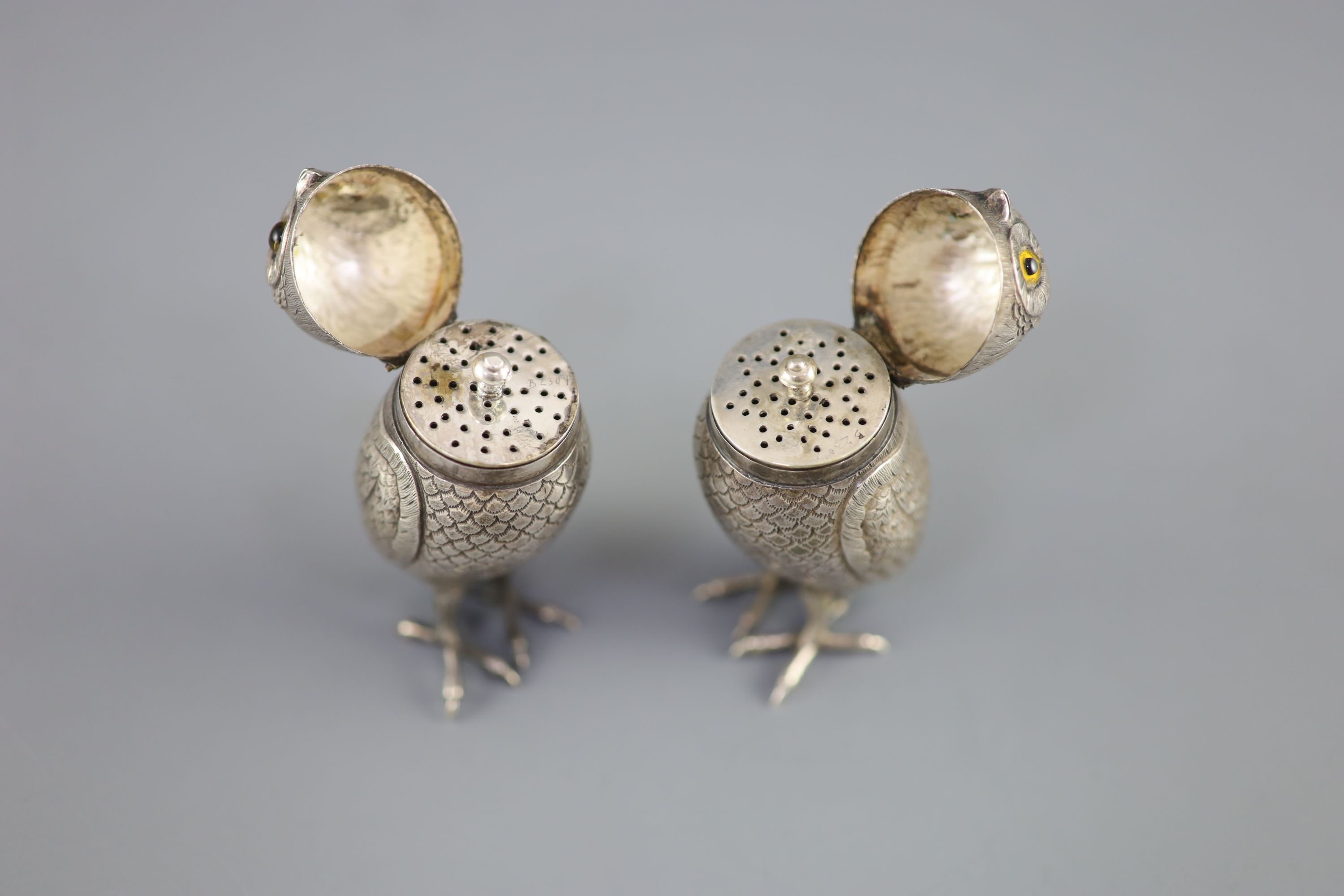 A pair of late 19th/early 20th century Dutch silver novelty pepperettes, modelled as owls